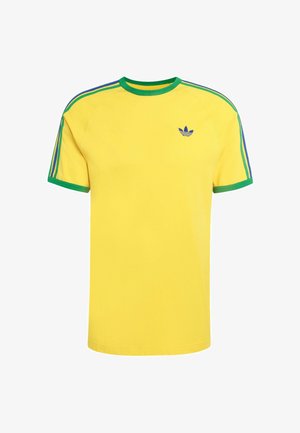 Žuta majica kratkih rukava s zelenim obrubom i tri plave pruge na svakom ramenom dijelu. Sadrži mali plavi Adidas logotip na prsima. Materijal od pamuka.