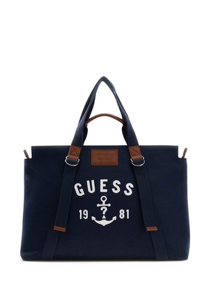 Sac cabas Guess bleu marine avec doubles poignées, accents en cuir, logo ancre blanc et texte « Guess 1981 » à l'avant.
