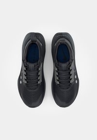 Black athletic shoes with a breathable upper, textured surface, gray accents, and rounded sole; features lacing and logo on insoles.
