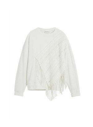 White sweatshirt with a textured, knitted poncho overlay featuring a fringed edge. The design is relaxed fit with long sleeves.