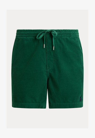 Short en velours côtelé vert avec ceinture élastique et cordon, avec un petit logo brodé sur la partie basse de la jambe gauche.