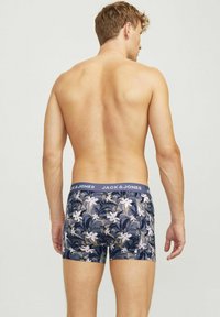 Boxer-briefs navy avec imprimé floral en blanc et vert. La ceinture élastique comporte le logo "JACK & JONES". Tissu extensible, design ajusté.