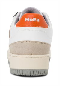 White sneaker with orange accent, suede grey heel, and textured rubber sole. Features stitched detailing and logo on the heel.