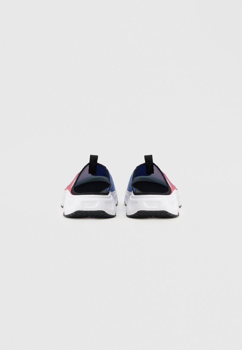 Slip-on sneakers med texturerad mesh-ovandel i färgblockdesign med rött, blått och svart, samt en vit gummisula med grepp.