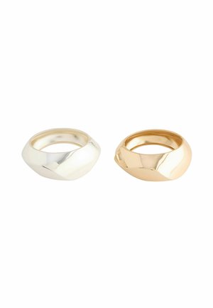 Two rings: one polished silver with a smooth, rounded shape and one polished gold with a similar design, both featuring a glossy finish.