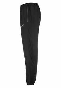 Zwarte sportbroek met een elastische tailleband en een zijzak met rits. Met het witte Nike-logo op de bovenbeen. Glad stof, taps toelopende pasvorm.