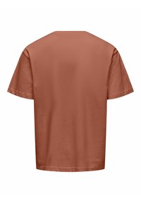 T-shirt uni à manches courtes de couleur terracotta vu de dos sur fond blanc.