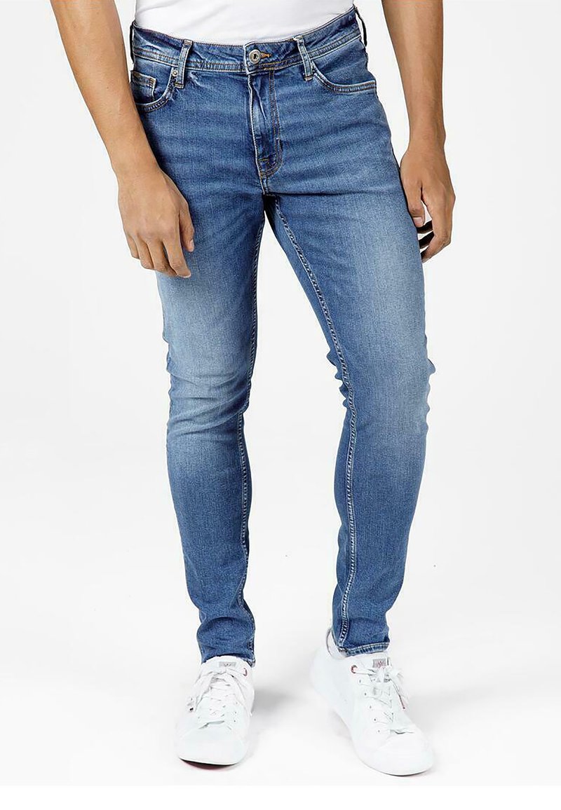 Skinny-fit denim jeans in light blue, featuring five pockets, a button closure, and subtle fading for added texture and detail.