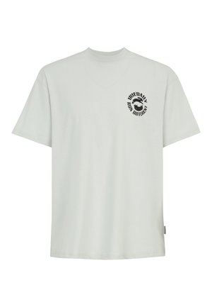 Light gray short-sleeve T-shirt with small black circular logo on left chest reading "IRIEDAILY RUN DIFFERENT" around two graphic elements.