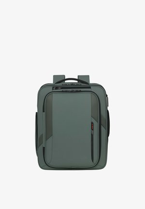 Compact gray soft-sided backpack with front zipper pocket, padded handle, and adjustable shoulder straps.
