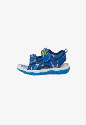 Sandalo blu per bambini con stampa di Sonic the Hedgehog, due cinturini regolabili, suola bianca e battistrada blu, mostrato su sfondo bianco.
