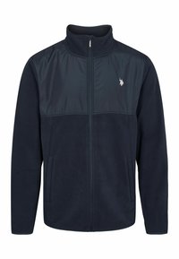 Giacca in pile blu navy con parte superiore in nylon liscio, colletto alto, cerniera completa e tasche laterali; presenta un piccolo logo sul petto.
