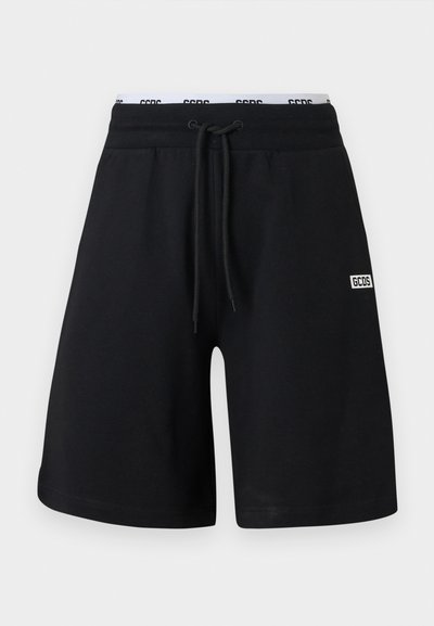 Schwarze Baumwollshorts mit einem elastischen Bund und Kordelzug. Mit einem weißen Logo-Patch am unteren linken Bein. Glatte Textur, gerader Schnitt.