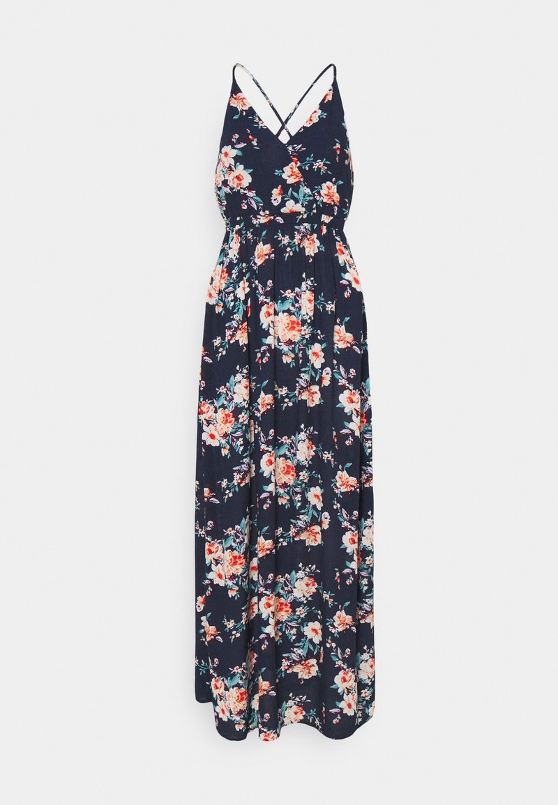 Robe maxi fleurie en bleu marine, avec un décolleté en V, des bretelles spaghetti croisées et une jupe fluide arborant un motif floral vibrant en rose et blanc.