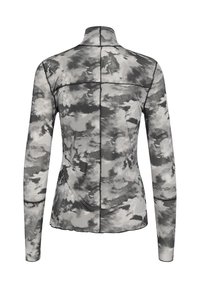 Maglietta a maniche lunghe da donna con motivo tie-dye nuvoloso in bianco e nero e cuciture nere visibili, mostrata da dietro.
