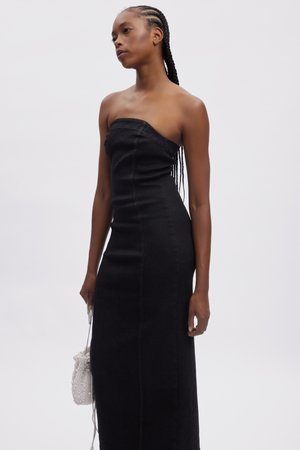 Black denim strapless dress with a fitted bodice and a straight, floor-length skirt. Contrast stitching details, smooth texture, minimal design.