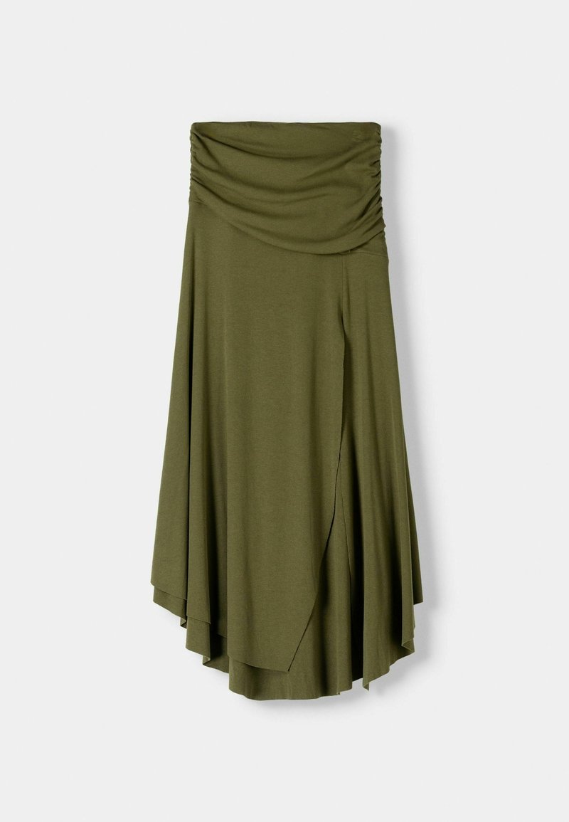 Jupe vert olive avec une taille froncée, tombant de manière asymétrique avec un design fluide, mettant en avant une texture de tissu lisse et léger.
