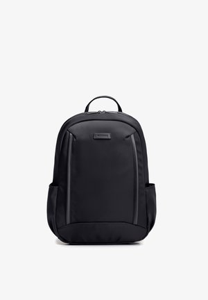 Zwarte rugzak met bovenhandvat, twee zijvakken, voorvak met rits en "WITTCHEN" merklabel op een glad oppervlak.