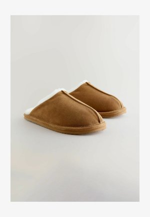Brown suede slippers with white fleece lining, curved design, and rubber sole. Seam details visible along the edges.