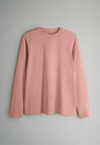 Cămașă cu mâneci lungi din bumbac roz pal, cu decolteu rotund, croială lejeră și textură netedă, fără modele sau accente vizibile.