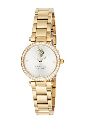 Montre analogique ton or avec lunette en cristal, cadran blanc, logo U.S. Polo Assn. et bracelet à maillons en métal.