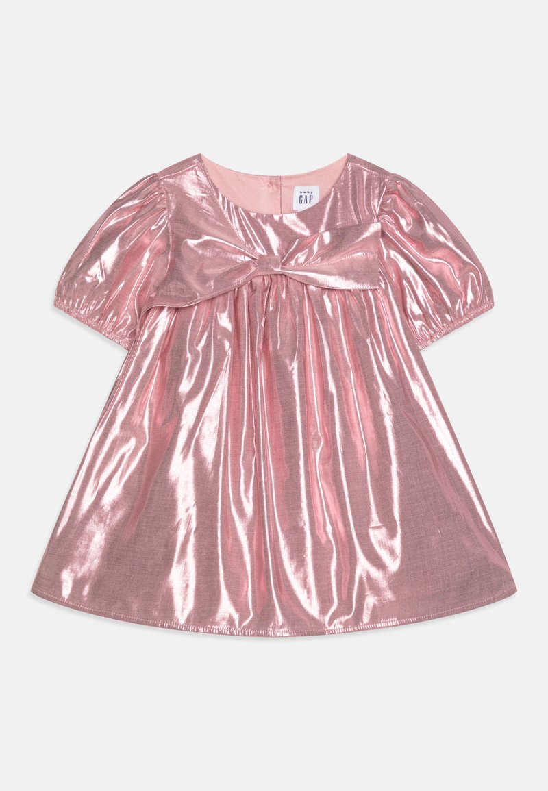 Pink, short-sleeve dress with a shiny, metallic finish. Features a gathered waist and a decorative bow at the front, creating a flared silhouette.