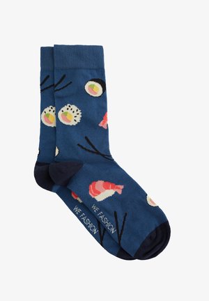 Blue socks featuring sushi patterns, including fish and rolls, with a dark navy heel and toe. Includes "WE FASHION" text near the ankle.
