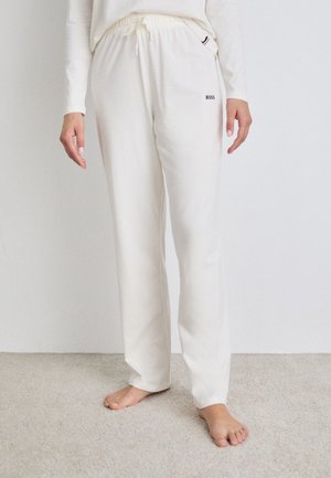 White, soft fabric lounge pants with an elastic waistband and drawstring, featuring side pockets and subtle black "BOSS" logo detail.