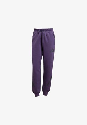 Pantalon de survêtement Adidas violet avec taille élastique, cordon de serrage, poches latérales zippées et chevilles resserrées.