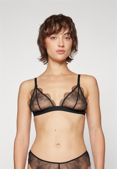 Schwarzer Spitzen-BH mit einem transparenten Design, gewellten Kanten, dünnen verstellbaren Trägern und einem stabilen schwarzen Unterband.