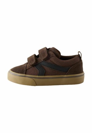 Brown children's sneaker with two velcro straps and a tan rubber sole, featuring a black zigzag design on the side.