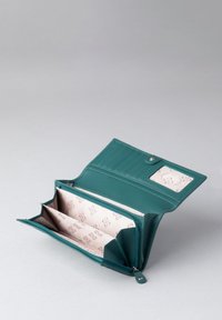 Teal leather wallet with a zip closure, multiple card slots, and a geometric patterned interior in light pink. Smooth texture and elegant shape.