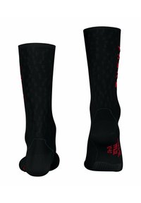 Calze sportive nere con tessuto texturizzato, design al ginocchio e scritte rosse. Presentano un tallone e una punta rinforzati per una maggiore durabilità.