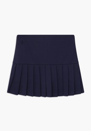 Jupe plissée bleu marine avec une ceinture ajustée. Fabriquée dans un tissu lisse. Présente un petit logo à la taille.