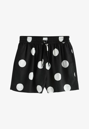 Crne kratke hlače s velikim bijelim točkama, elastičnim pojasom i prednjim vezicama.