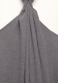 Gray textured fabric draped and knotted at the top, featuring a subtle wrinkled surface and a wide, flowing shape.