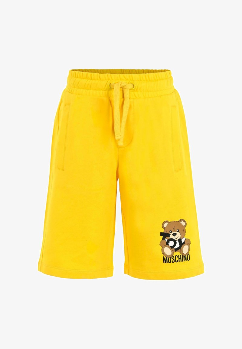 Gele shorts met elastische tailleband en drawstring, voorzakken, en een teddybeer die "Toy" vasthoudt met de tekst "Moschino" op het been.