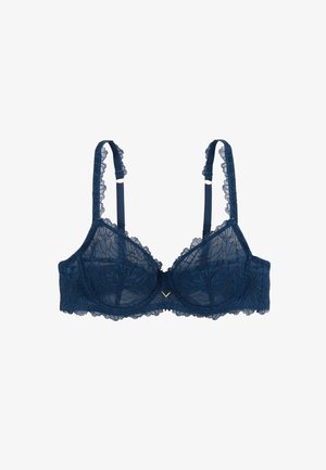 Soutien-gorge en dentelle marine avec motif floral, soutien à baleines, bretelles ajustables et bords festonnés. Présente un petit accent doré au centre avant.