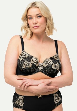 Zwart kanten beha met goudkleurige bloemembroidery, voorzien van verstelbare bandjes en een strikaccent aan de voorkant. Ontworpen met beugels voor ondersteuning.