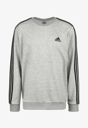 Jasnoszara bluza Adidas z czarnymi trzema paskami na rękawach i logo Adidas na lewej piersi, z okrągłym dekoltem i ściągaczami na mankietach.