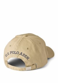 Khaki baseball cap with embroidered "U.S. Polo Assn." logo in navy, adjustable strap, and textured cotton fabric.