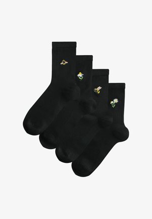 Black socks featuring assorted embroidered designs: bees and flowers. Each sock has a ribbed cuff and a smooth texture. Four pairs included.