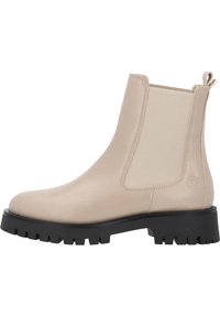 Botas de tobillo de cuero beige con paneles laterales elásticos, puntera redondeada y suela de goma negra texturizada con profundas ranuras para tracción.