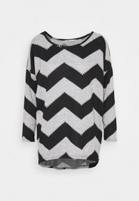 Schwarz und grau gestreifte Langarmbluse mit Zickzackmuster; aus weichem Stoff gefertigt, hat einen runden Ausschnitt und einen leicht abgerundeten Saum.