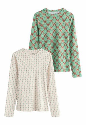 Two long-sleeve shirts: one mint green with red bows and ornaments, the other cream with green floral patterns. Both feature round necklines.
