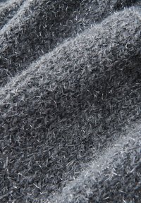 Dark grey knitted fabric with a textured surface, featuring fine, reflective strands throughout, creating a soft, fuzzy appearance.