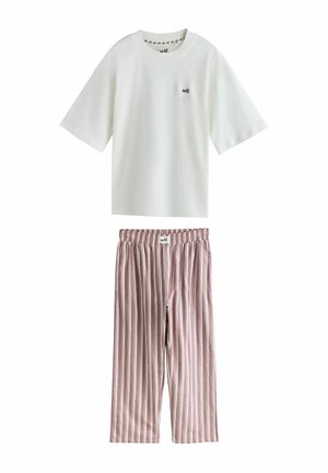 White short-sleeve shirt with "self." logo paired with loose, striped pink and white elastic-waist pants with front buttons and "self." label.