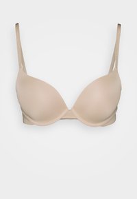 Soutien-gorge rembourré beige avec des straps ajustables, design sans couture et texture lisse, doté d'une fermeture à crochets au dos.