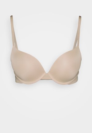 Sutiã bege acolchoado com alças ajustáveis, design sem emendas e uma textura suave, apresentando um fecho de gancho e olho na parte de trás.
