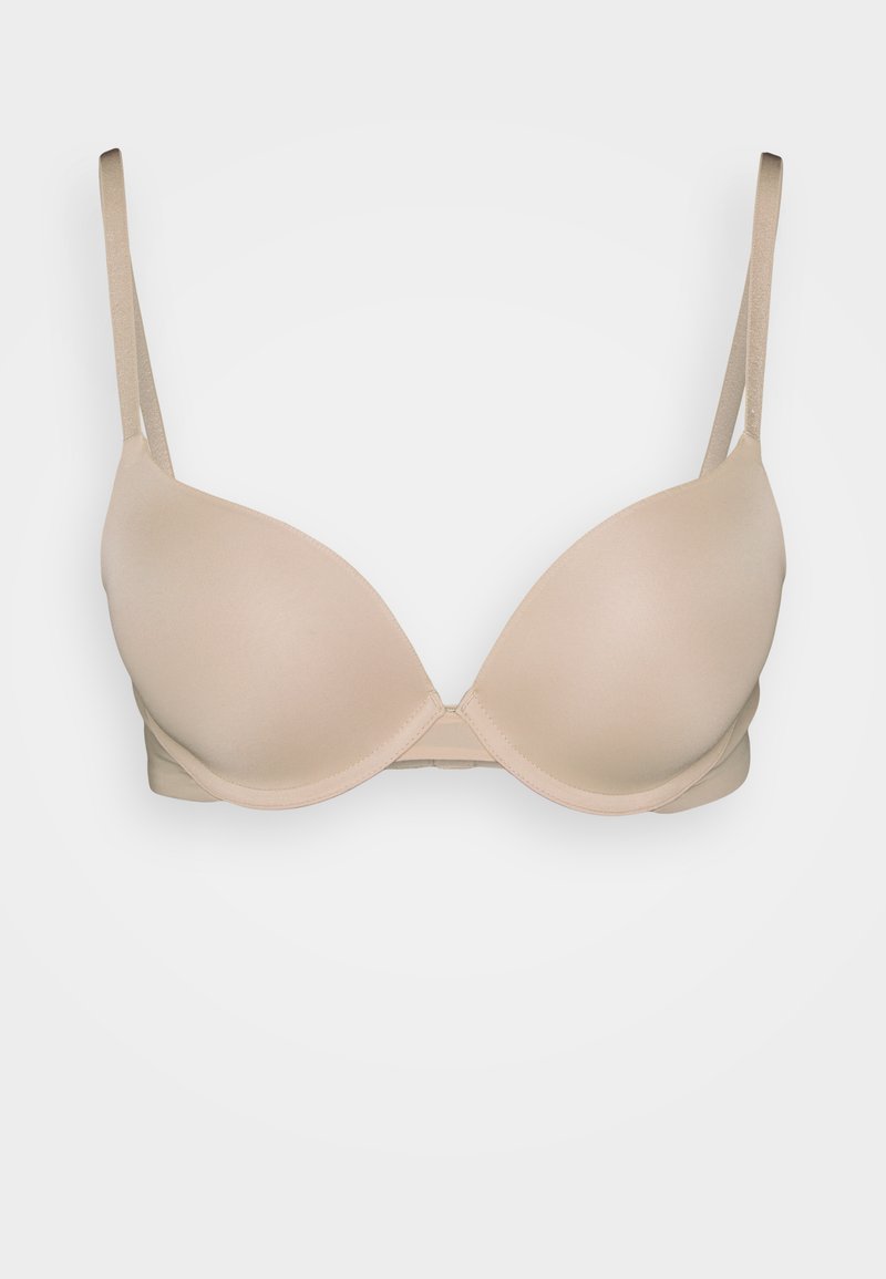 Soutien-gorge rembourré beige avec des straps ajustables, design sans couture et texture lisse, doté d'une fermeture à crochets au dos.